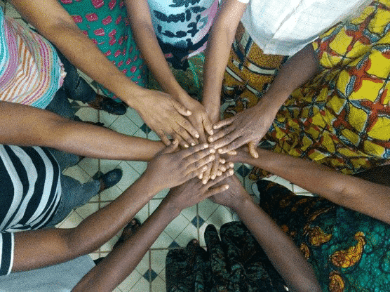 Hands together in a huddle