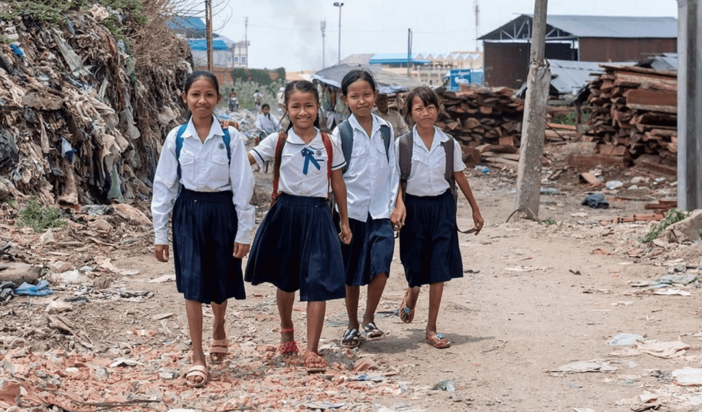 Four girl students walking outside together