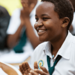 Student smiling and clapping