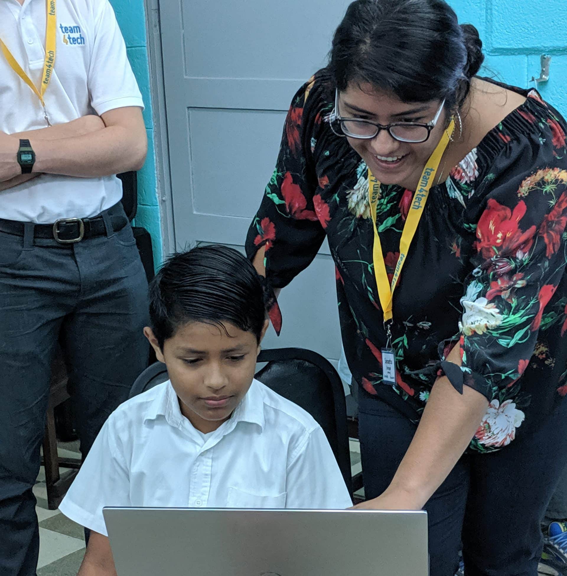 Teacher helping student with technology