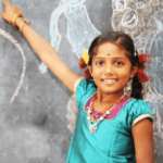 Girl pointing at chalkboard