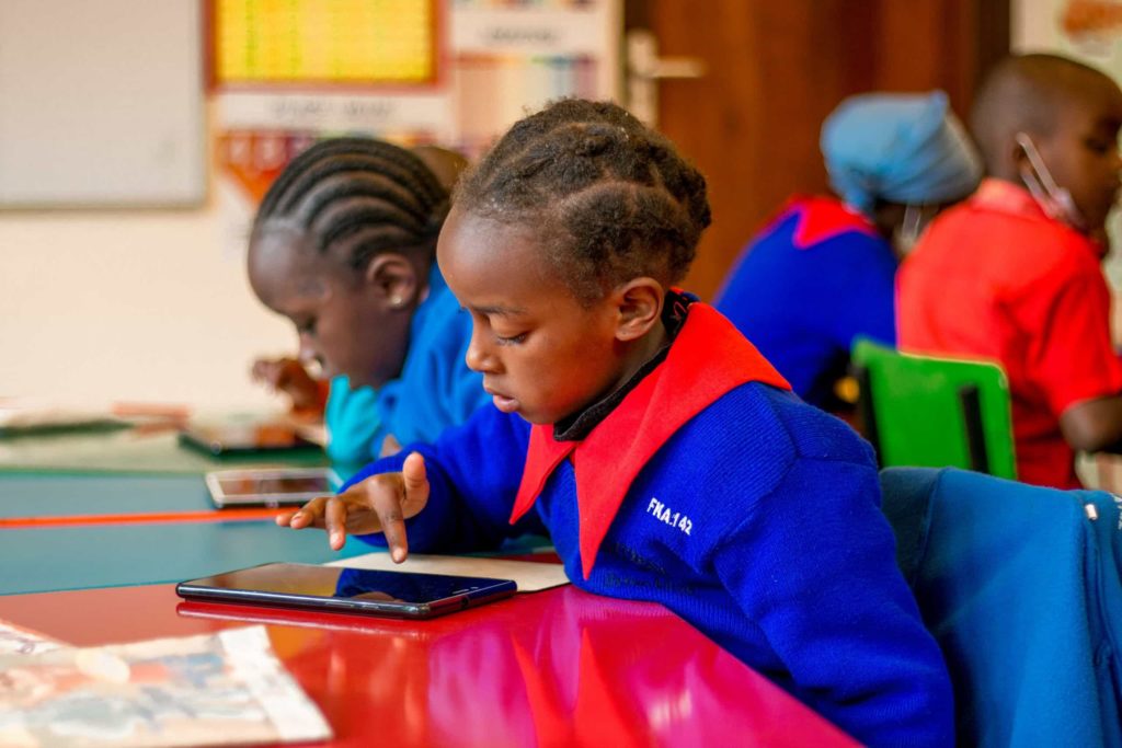 Student using tablet. Flying Kites improves access to training in digital skills in rural Kenya.