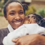 Woman embracing child. RefuSHE improves access to resources in digital skills for refugee girls.
