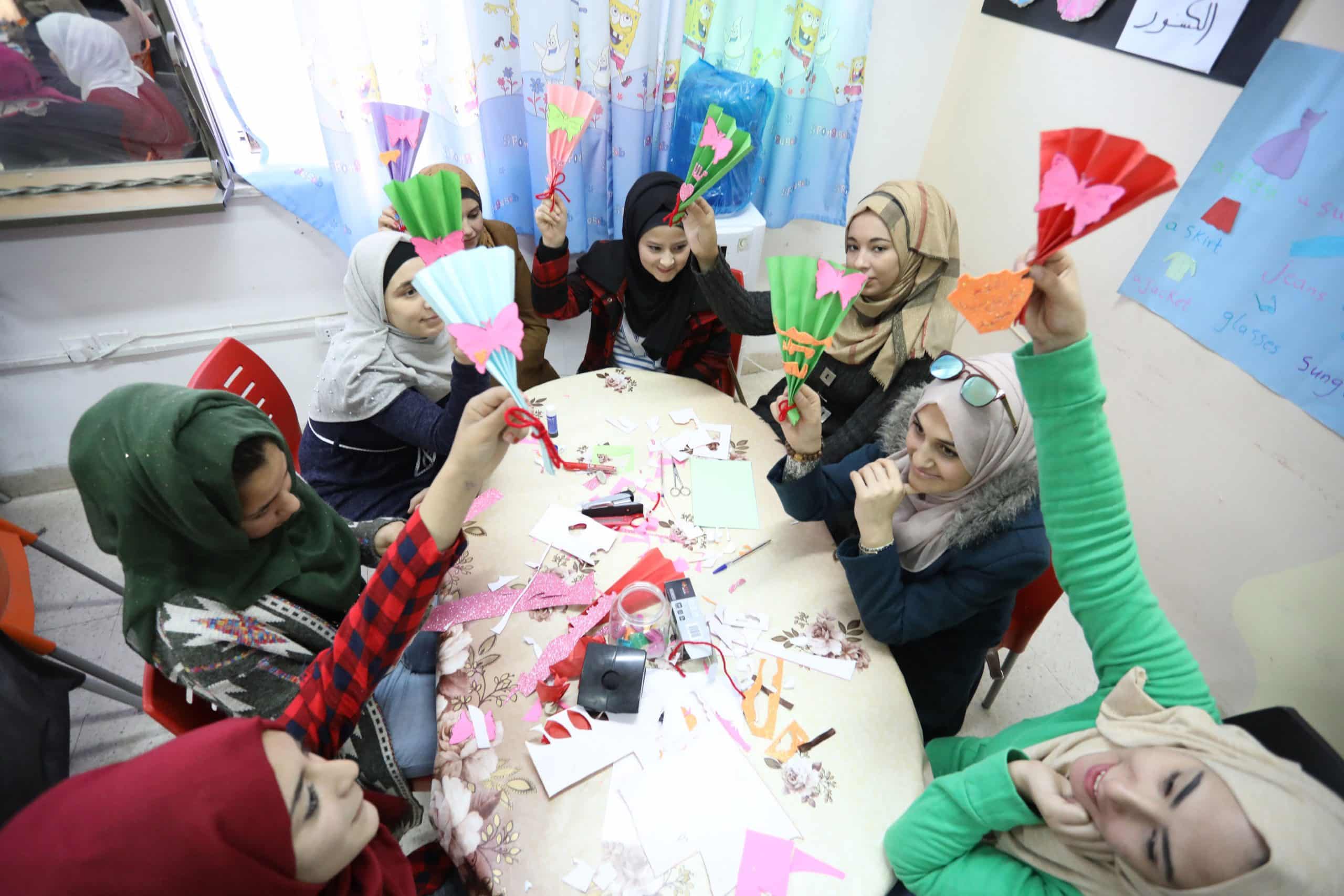 Girls sit around table and engage in Questscope's program for adaptive learning in Jordan