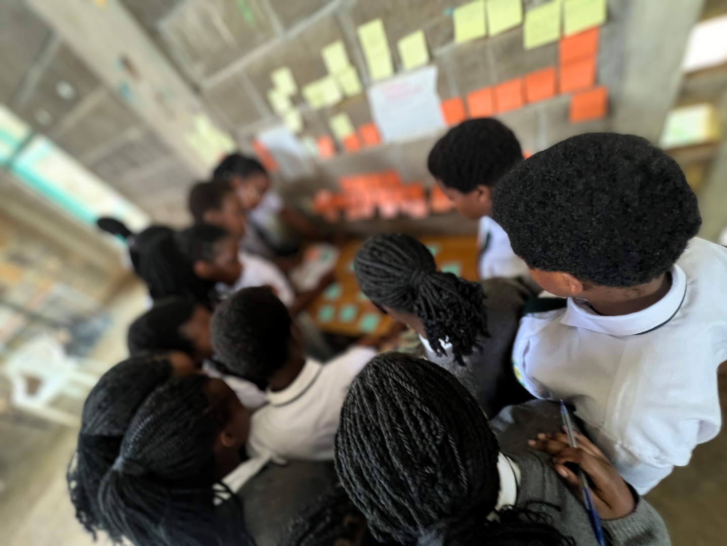 Students at Gashora Girls Academy in Rwanda working on a Team4Tech project with skilled volunteers from Salesforce in 2024