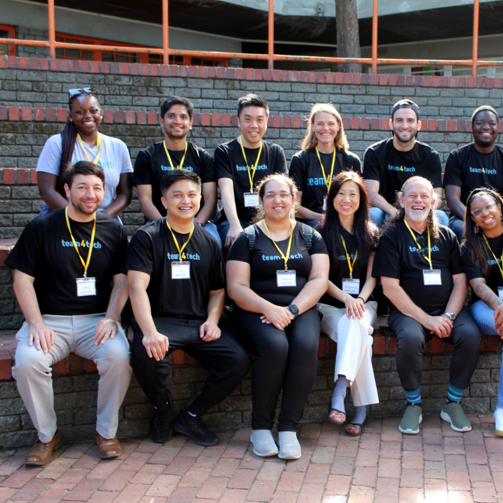 Line of people in Team4Tech t-shirts and yellow lanyards.